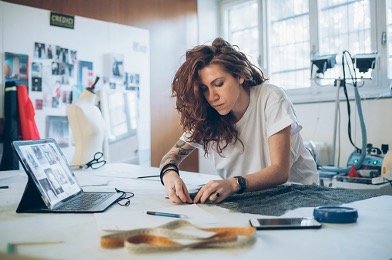 Woman designing in her fashion studio at home