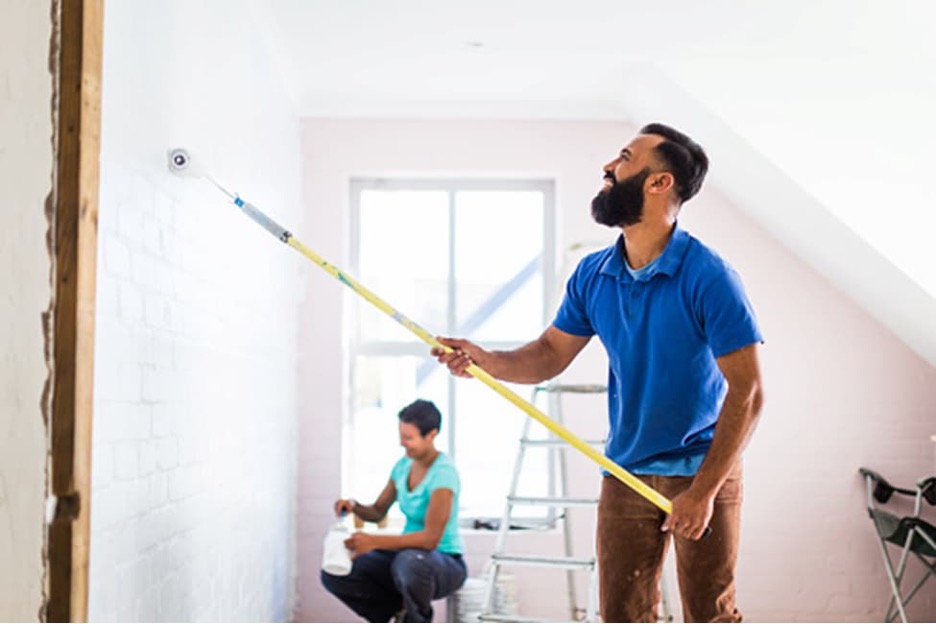 a couple painting their new home