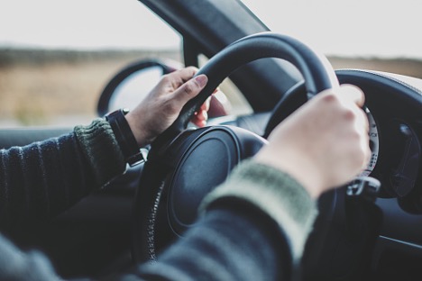 hands on a car steering wheel